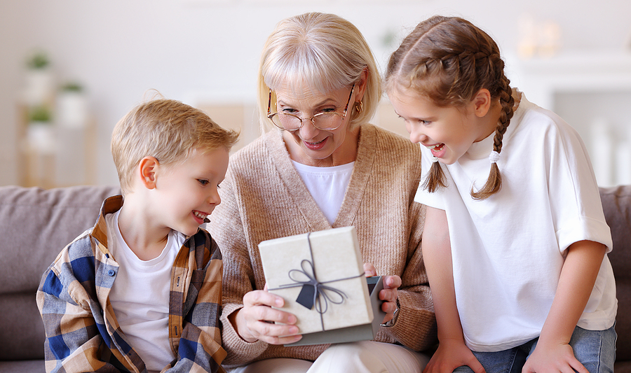 grandmother opening gift from grandchildren