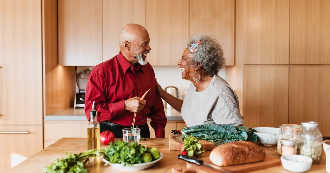 Senior Couple Cooking in Kitchen Together