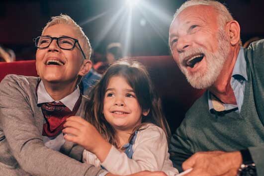 seniors and granddaughter at a movie