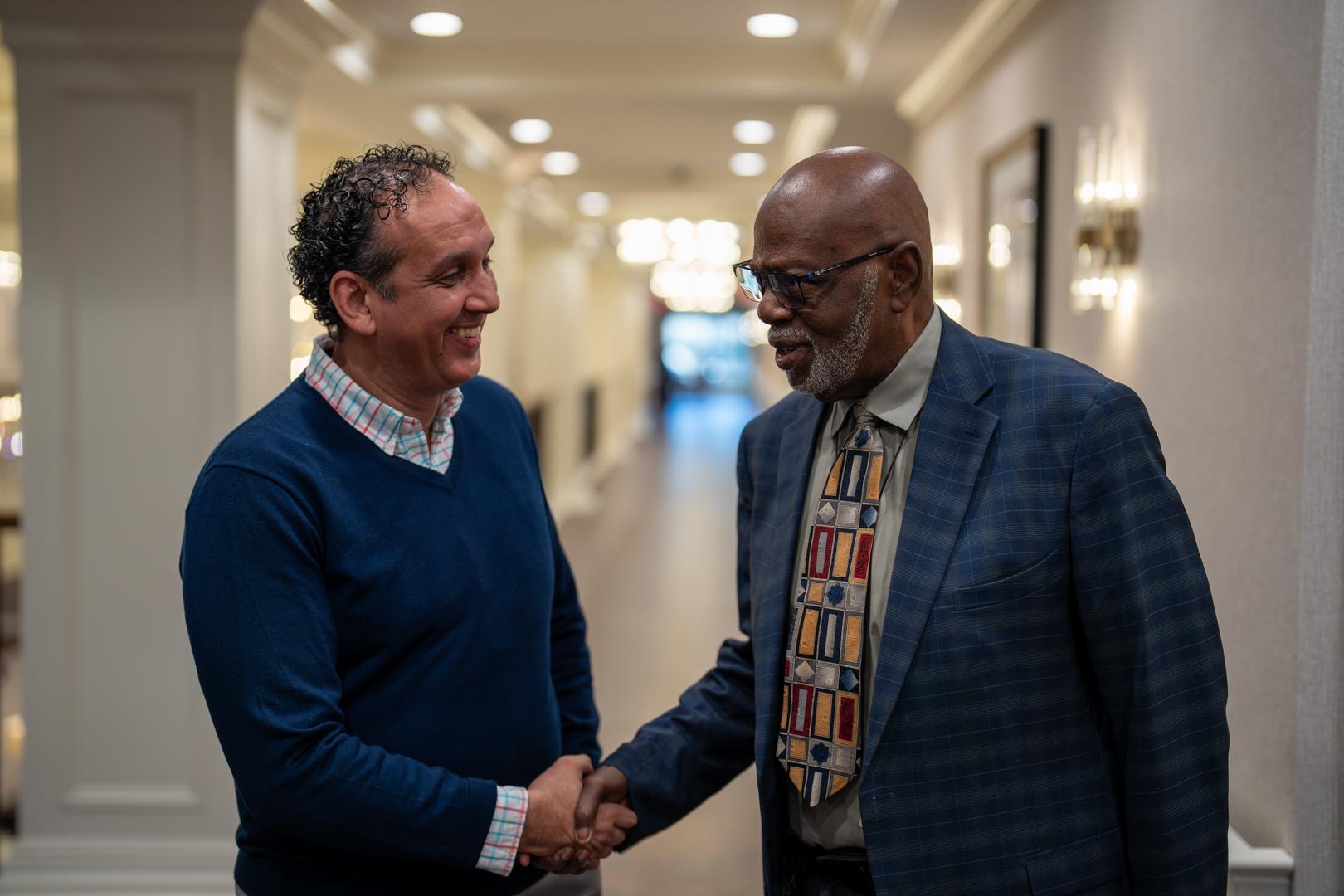 resident shaking hand with employee