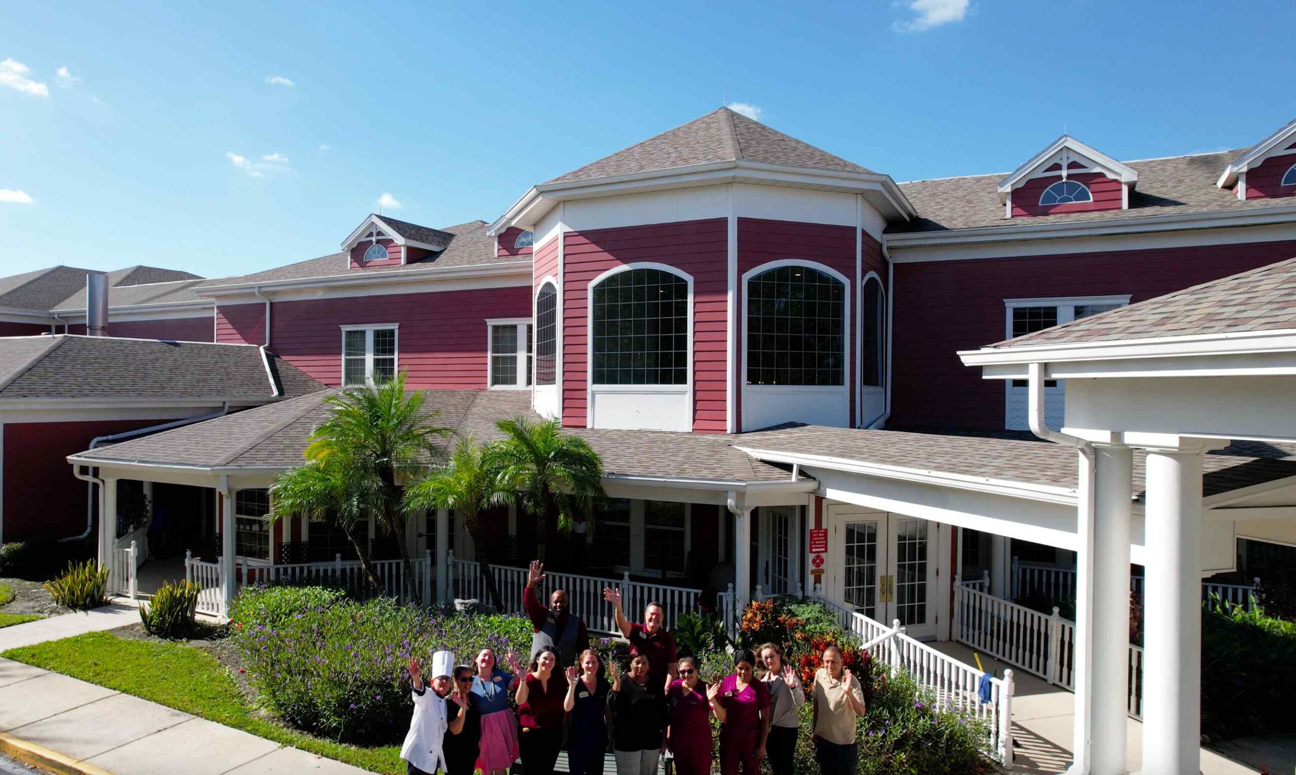 hunters creek exterior with employees waving