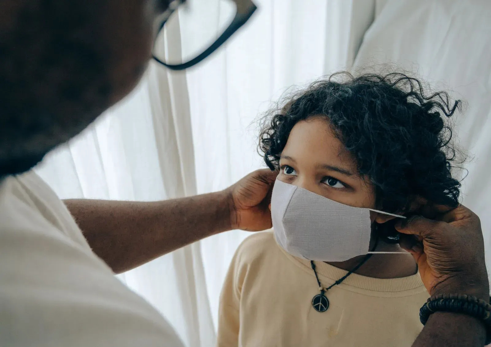 Child putting mask on