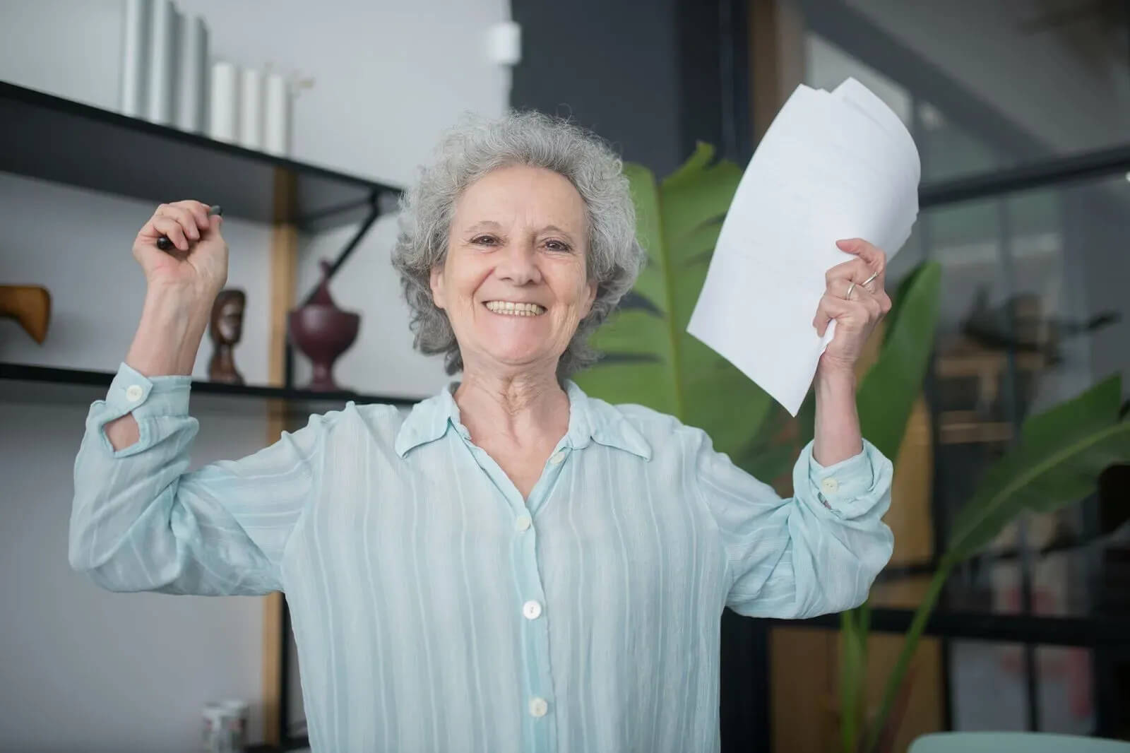 Woman holding paper excited