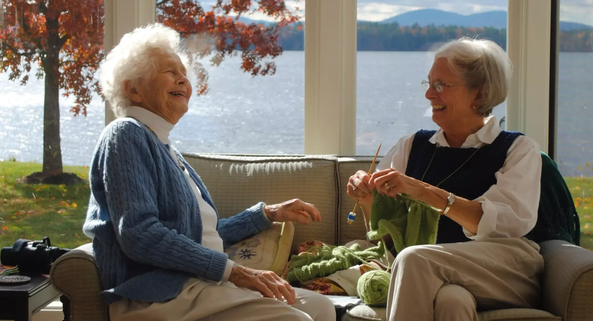Elderly women having a laugh while knitting
